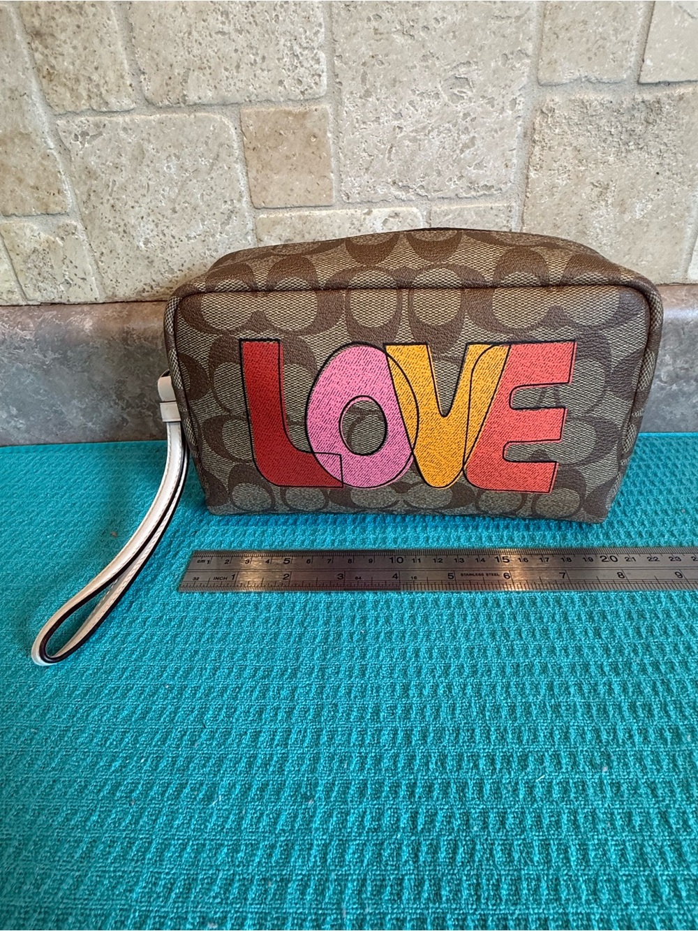 Coach Brown Signature Wristlet with Pink, Yellow and Red LOVE Graphic